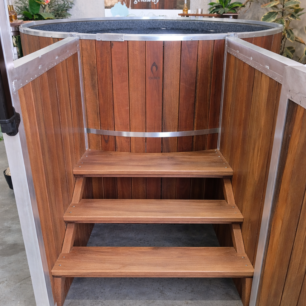 Wooden hot tub with steps on a concrete floor